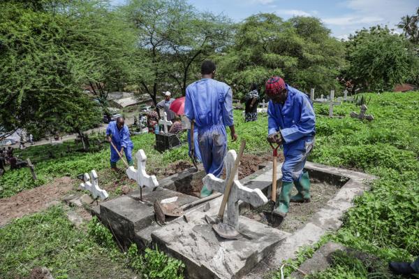 Image from Ericky Boniphace | Even The Dead can't Escape Climate Change -  Labourers prepare to dig down into graves as they...