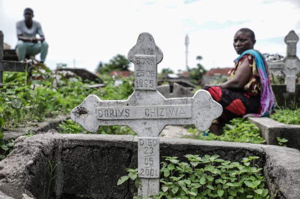 Image from Ericky Boniphace | Even The Dead can't Escape Climate Change -  A woman sits beside a grave during the process of...