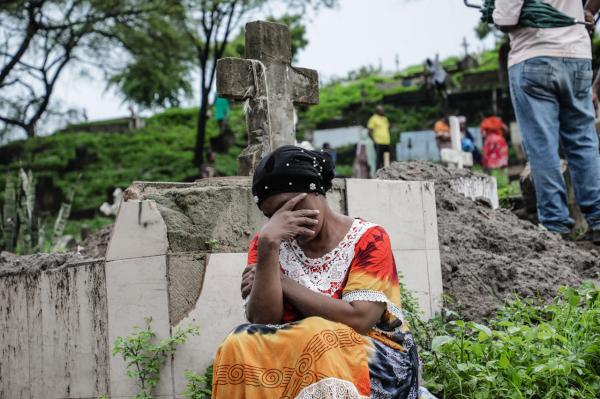 Image from Ericky Boniphace | Even The Dead can't Escape Climate Change -  A woman sits near where workers are digging up grave...