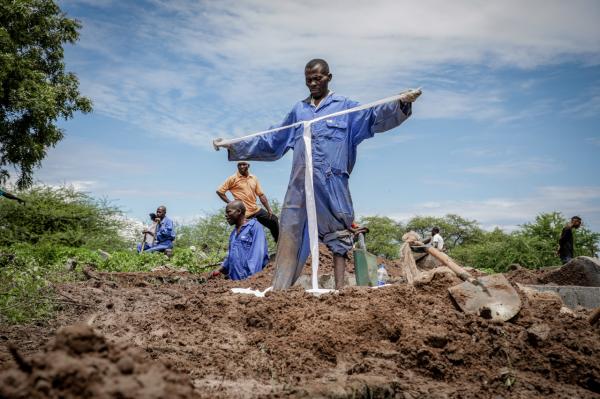 Image from Ericky Boniphace | Even The Dead can't Escape Climate Change -  A man prepares to collect human remains from a grave at...