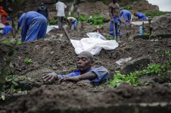 Image from Ericky Boniphace | Even The Dead can't Escape Climate Change -  A man prepares to collect human remains from a grave at...