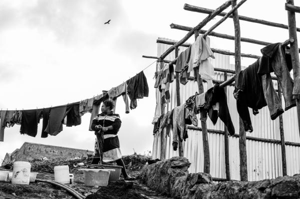 Image from Gordwin Odhiambo | A Changing Community and the Fears Ahead -  A woman washes clothes in the Raila area of Kibera,...