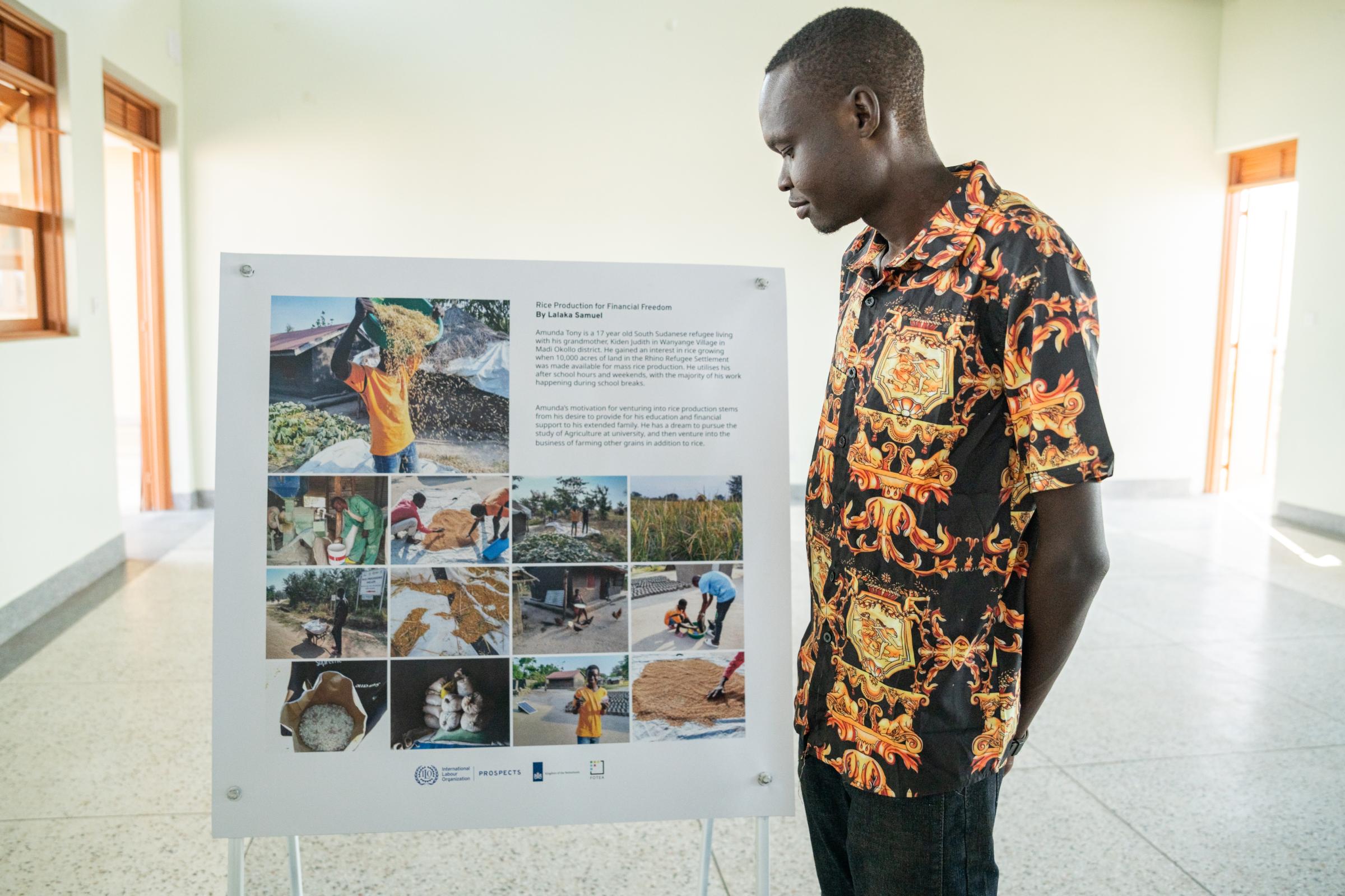 Unveiled Visions Exhibition & Book Launched - Winner, Lalaka Samuel, looking at his work.&nbsp;