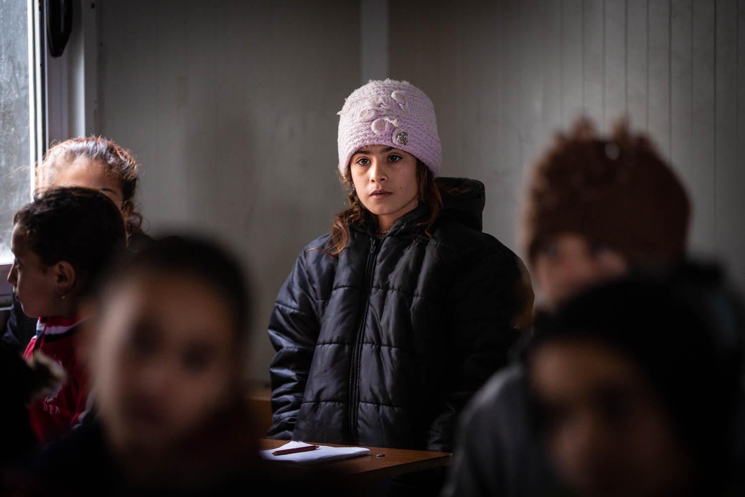 Education Whilst Displaced - Sahara, age 8, stands during a lesson inside of a...