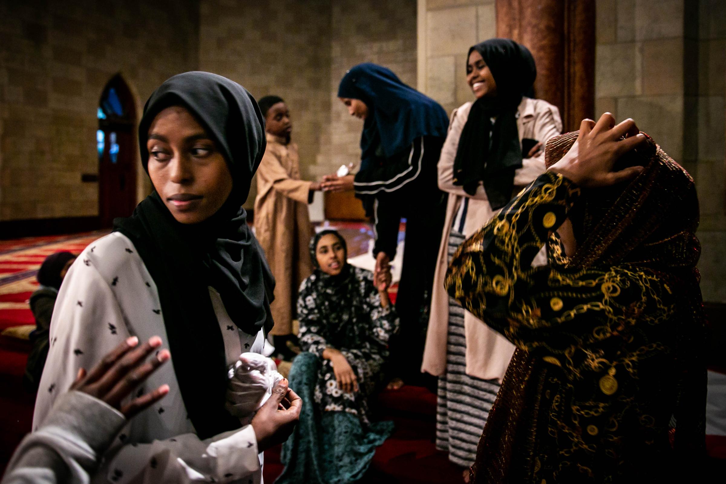 The Geography of Belonging - A group of Muslim young women gossip as they wait for the...