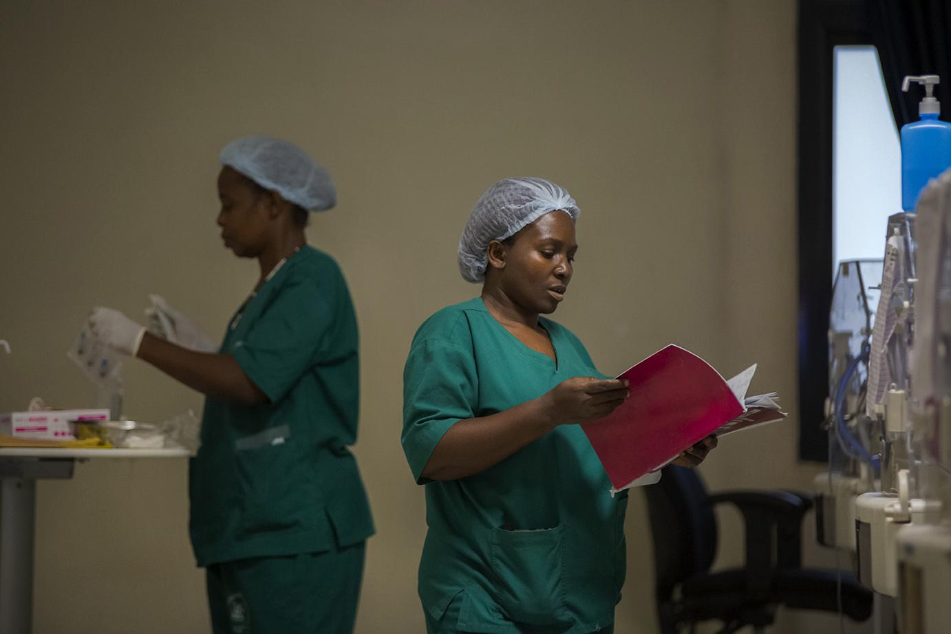 Nurse Kabasinguzi Jemirah (left...tal Intensive Care Unit (NICU).