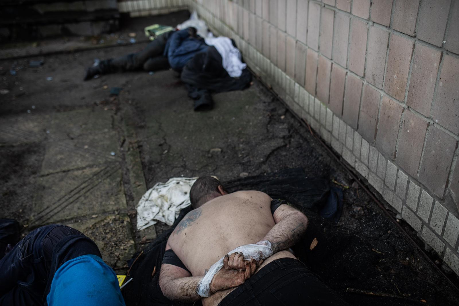 THE BUCHA MASSACRE - The lifeless body of Andriy, 32, lies on the ground,...