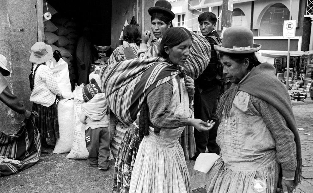 ILLIMANI -  The beggar sat on the ground, raised her clasped hands...