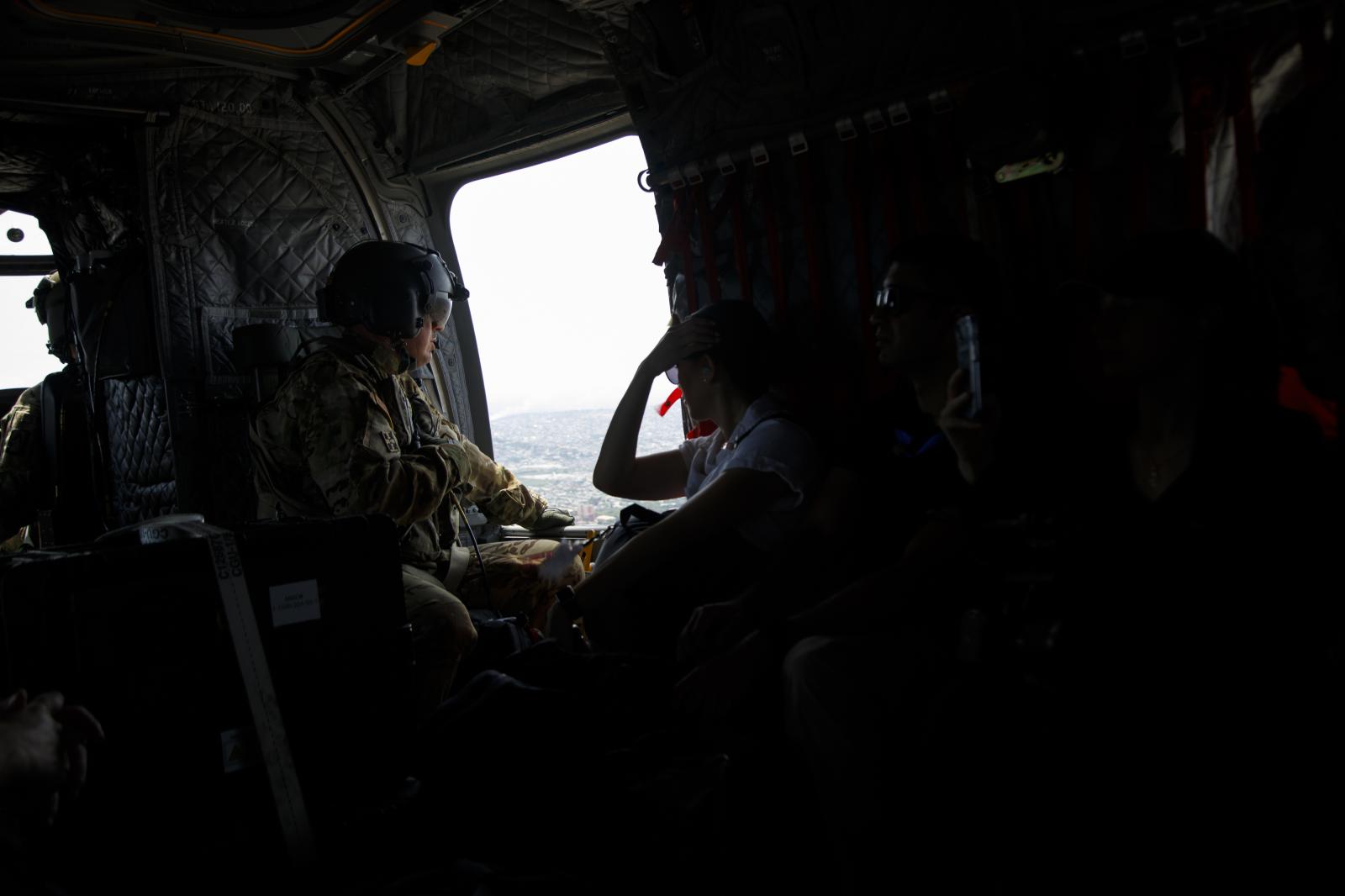 Image from U.S. Vice President Kamala Harris Visit To Ghana - A military man in a helicopter en route to Cape Coast in...