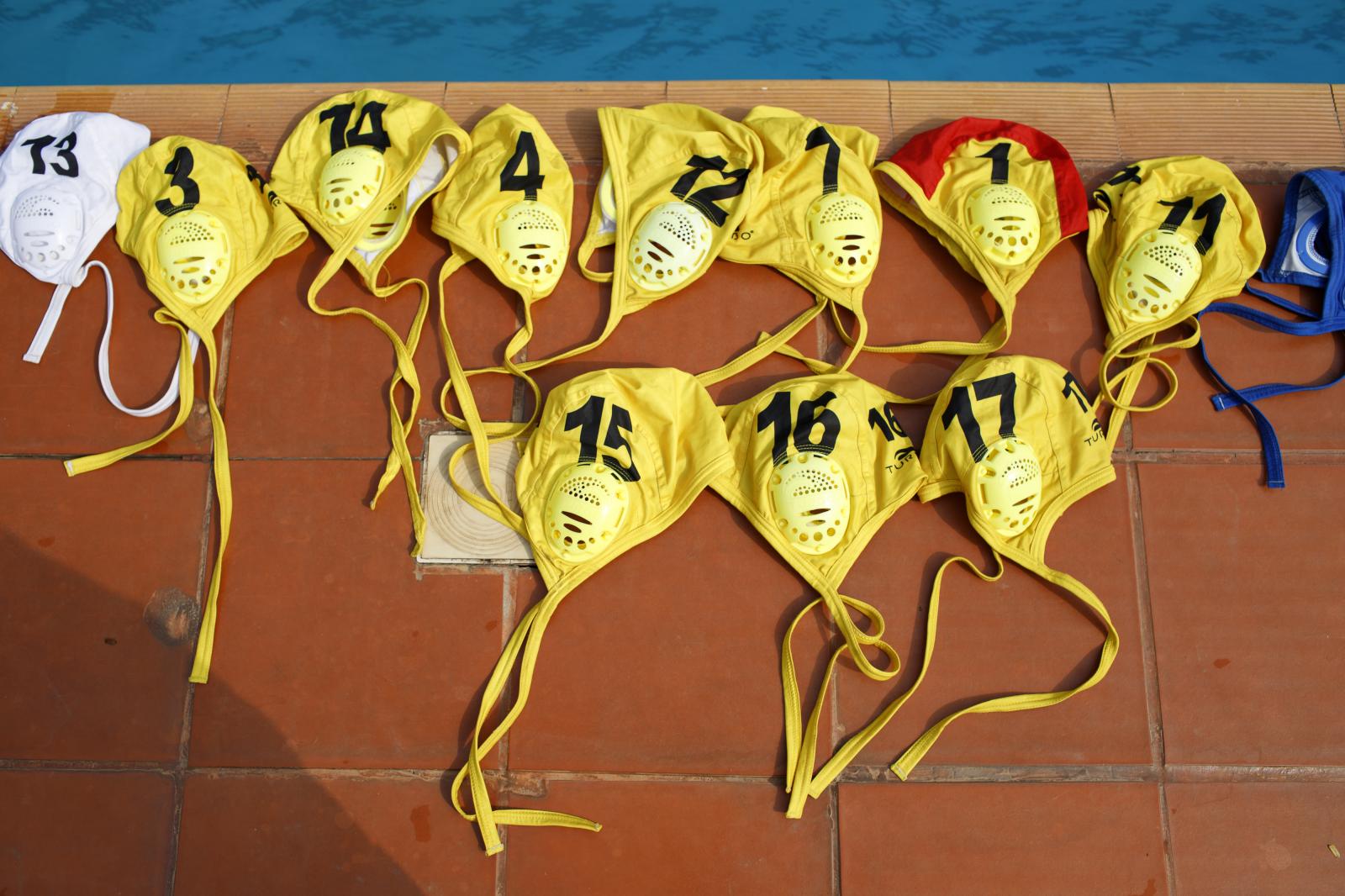 Water Polo - Water polo caps are displayed by the poolside during an...