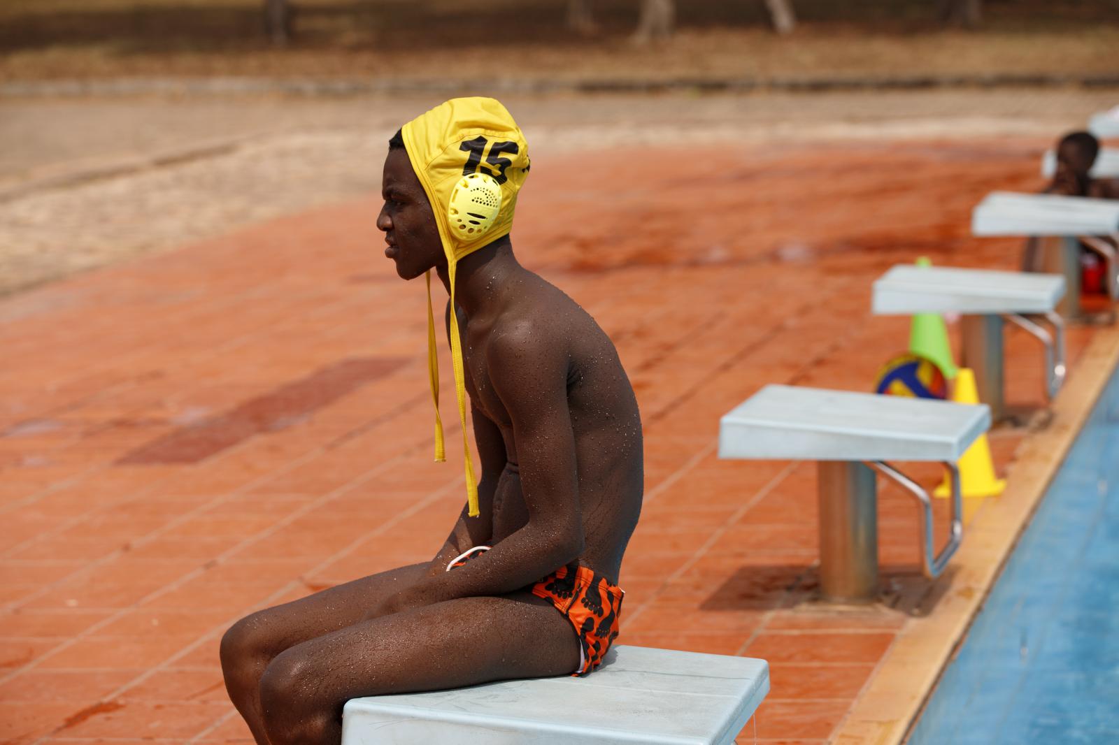 Image from Water Polo - A boy sits by the poolside during an Awutu Winton Water...