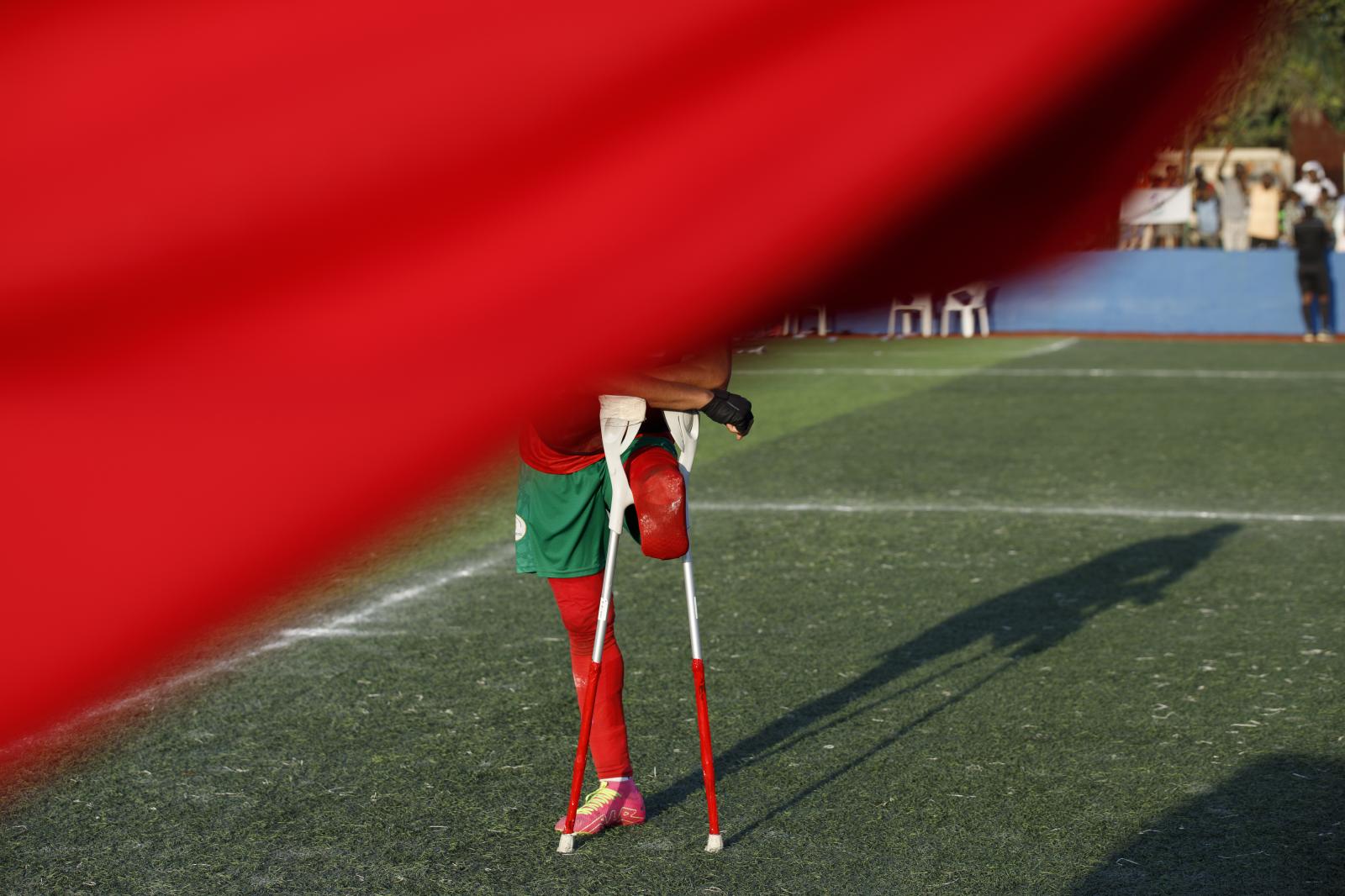 Image from First African Para Games  - A Moroccan amputee football player stands on the pitch...