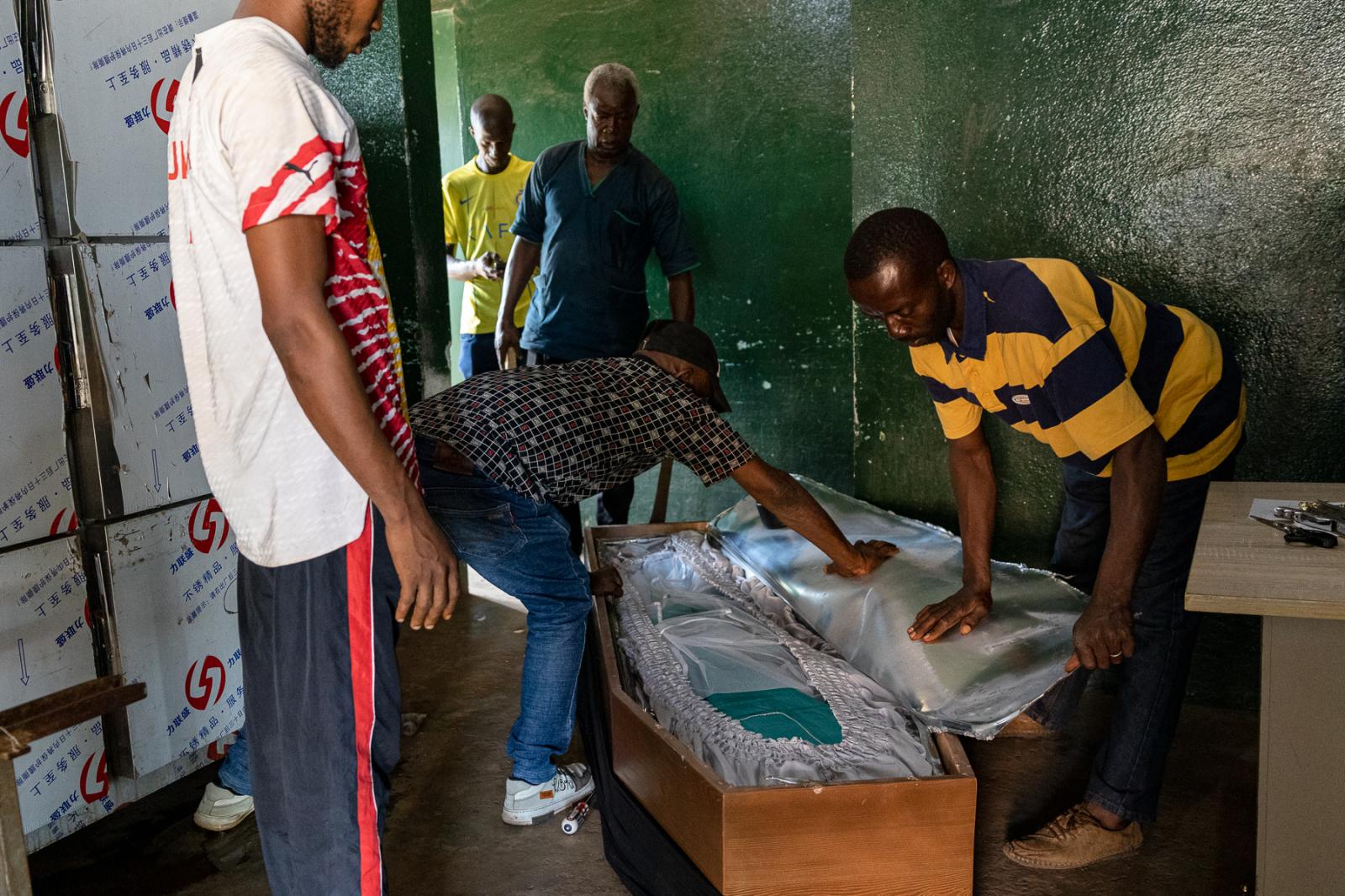 In Guinea’s capital, a heartbroken family brings their son’s body home