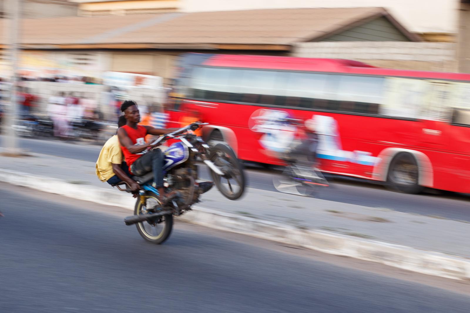Motorcycle stunts on the streets of Jamestown in Accra, Ghana.