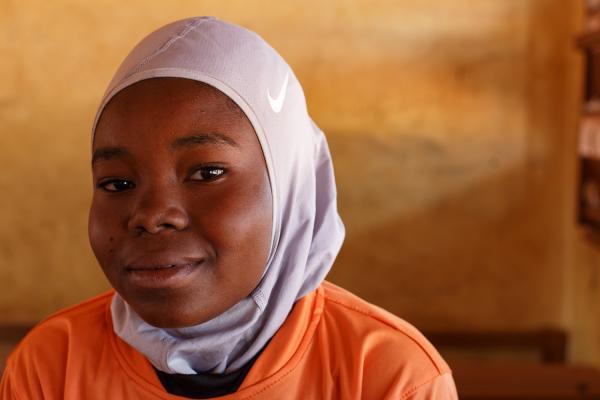 Faith and Football - Khadija, 13 years old, poses for a photograph in a Nike...