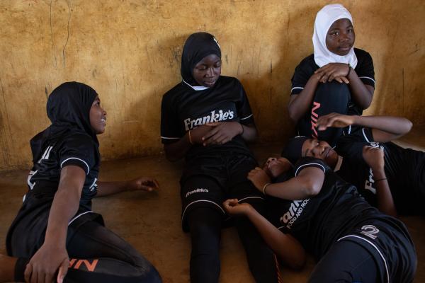 Faith and Football - Girls chat in a classroom during the 'hijab...