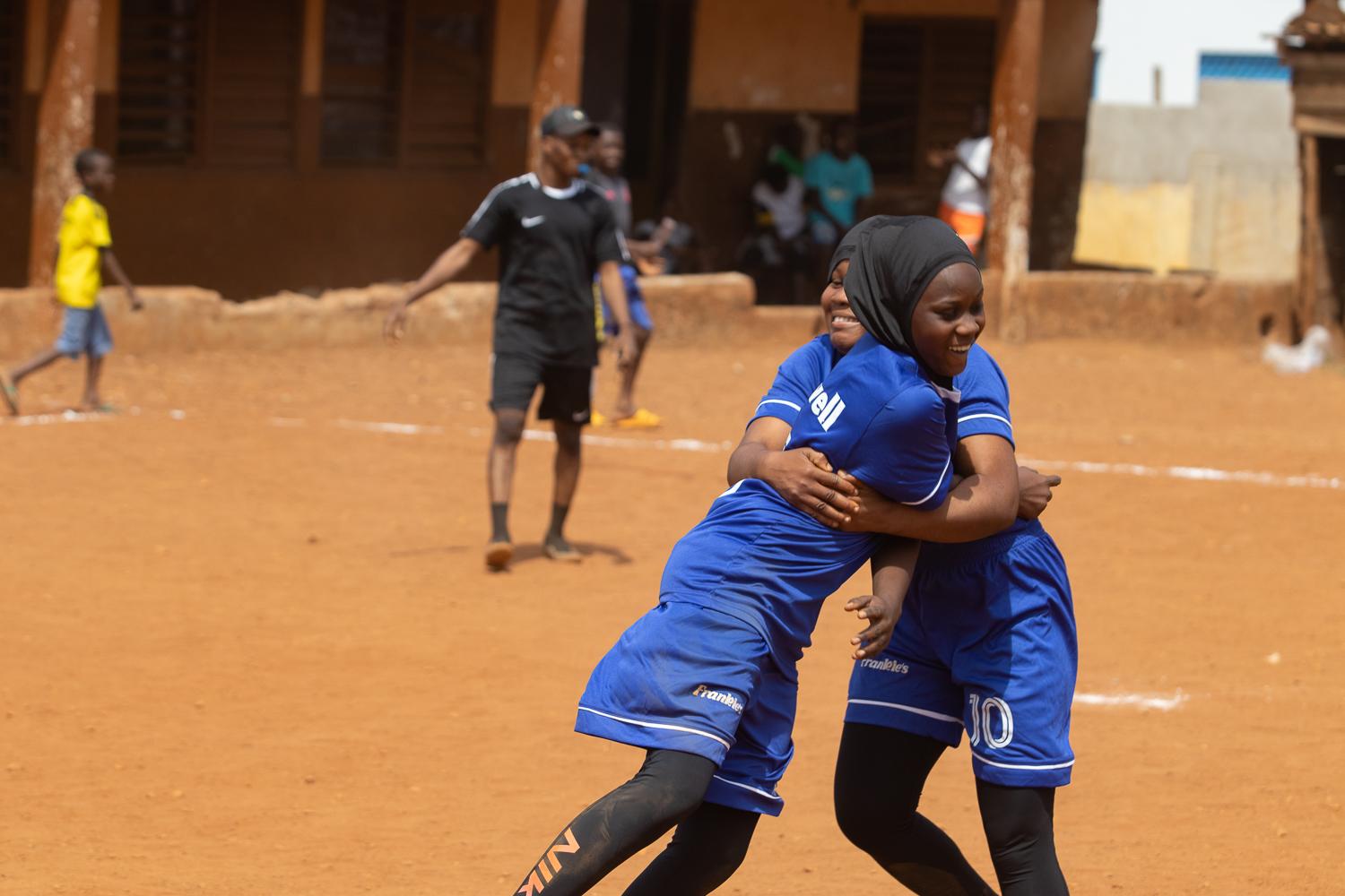 Image from Faith and Football - Two girls celebrate a win during the 'hijab...