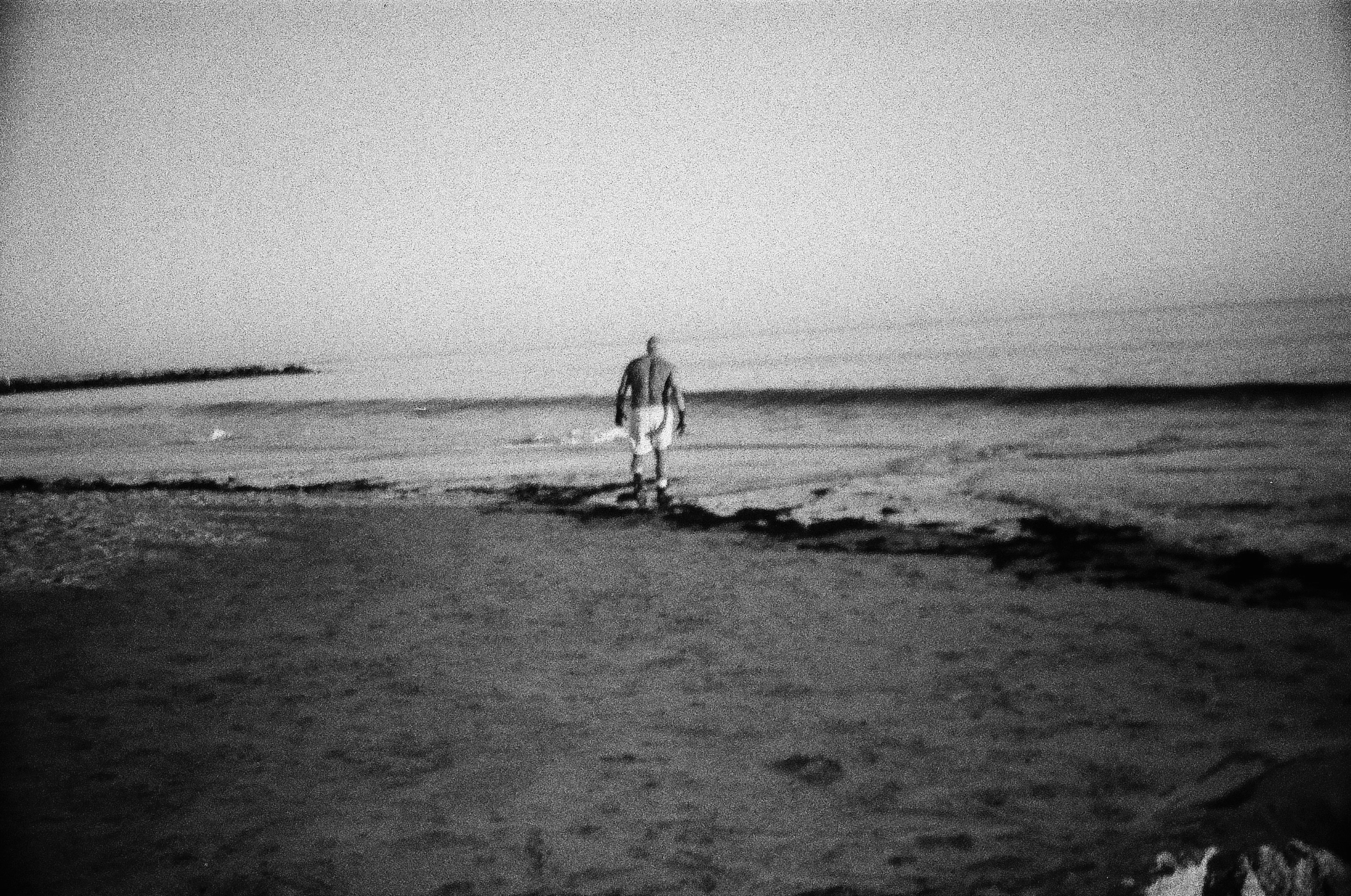 César Andrade - Cold Water Swimmer -  César Andrade walking toward the shoreline....