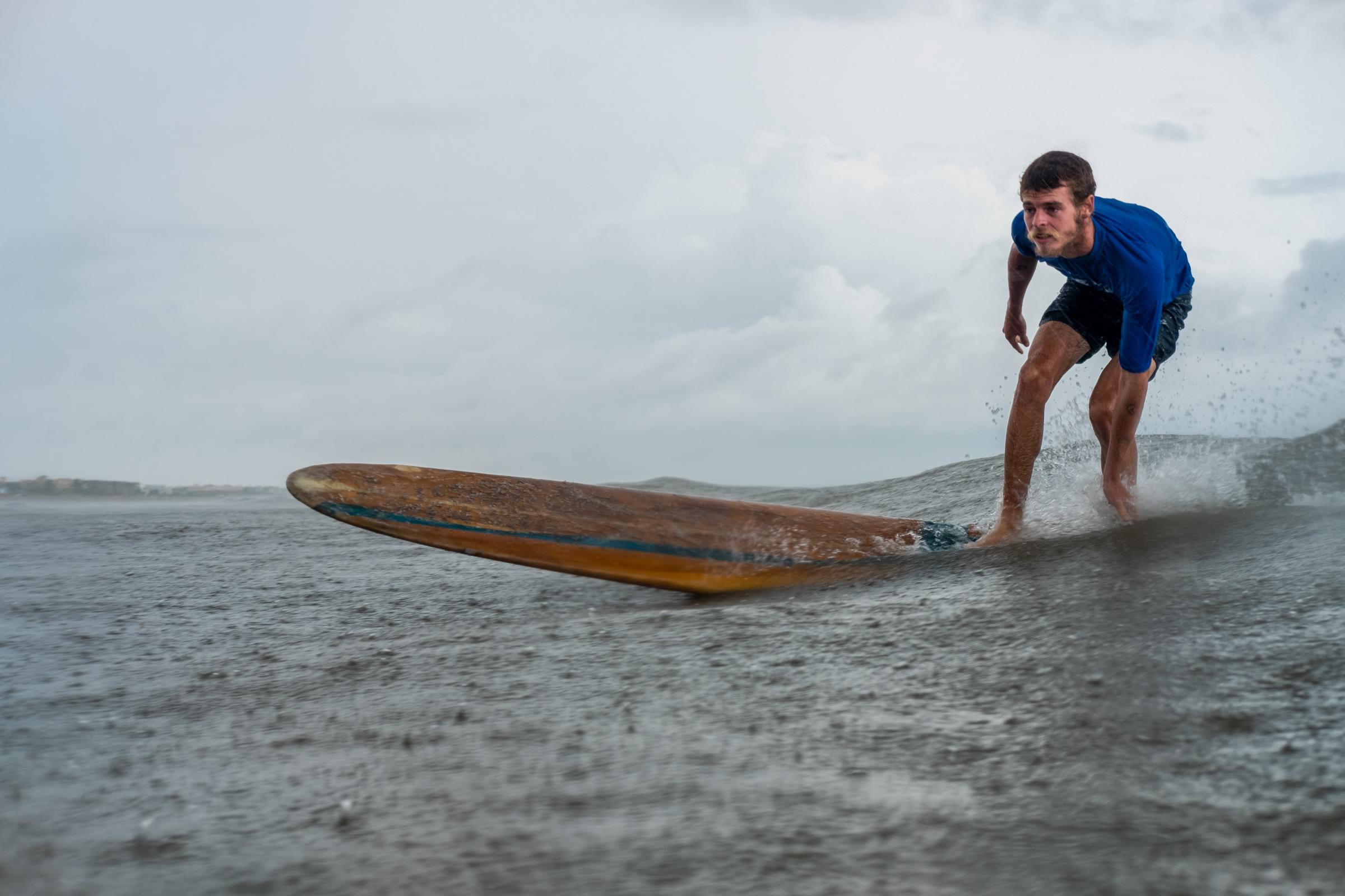 Cape Canaveral, FL. Hotdogzonastix Surf Contest July 2021 -  Patrick Conklin bottom turning on a 1960s longboard at...