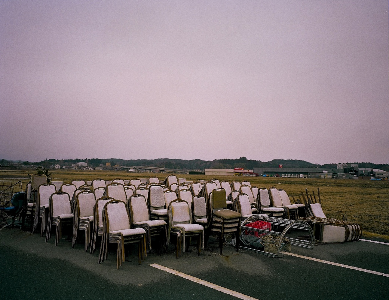 Life within 90 km -  Abandoned chairs from a celebration hall sit in an empty...