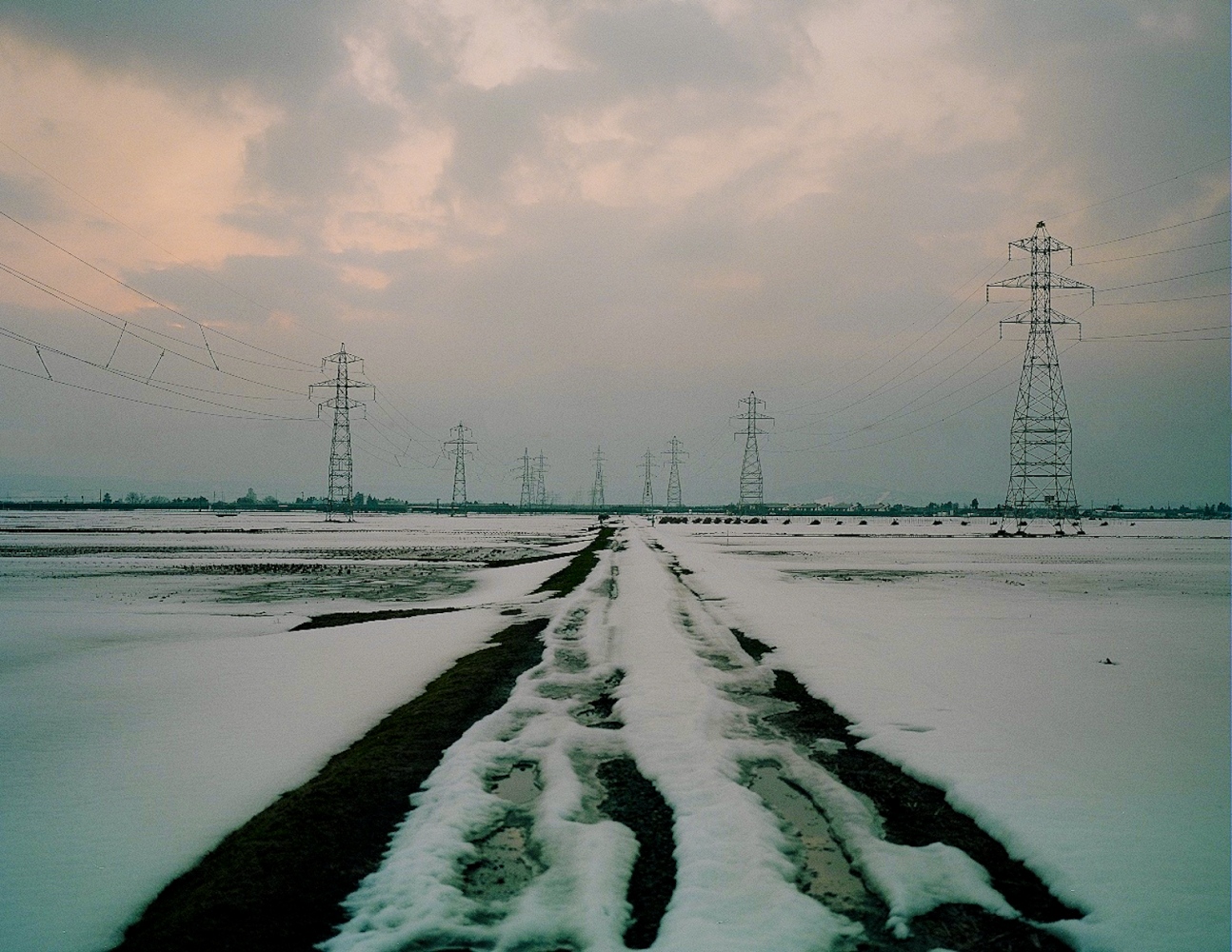 Life within 90 km -  Electric towers line the landscape of a snow covered sea...