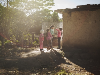 Image from Children having Children -  Lilian and her younger siblings playing around their...