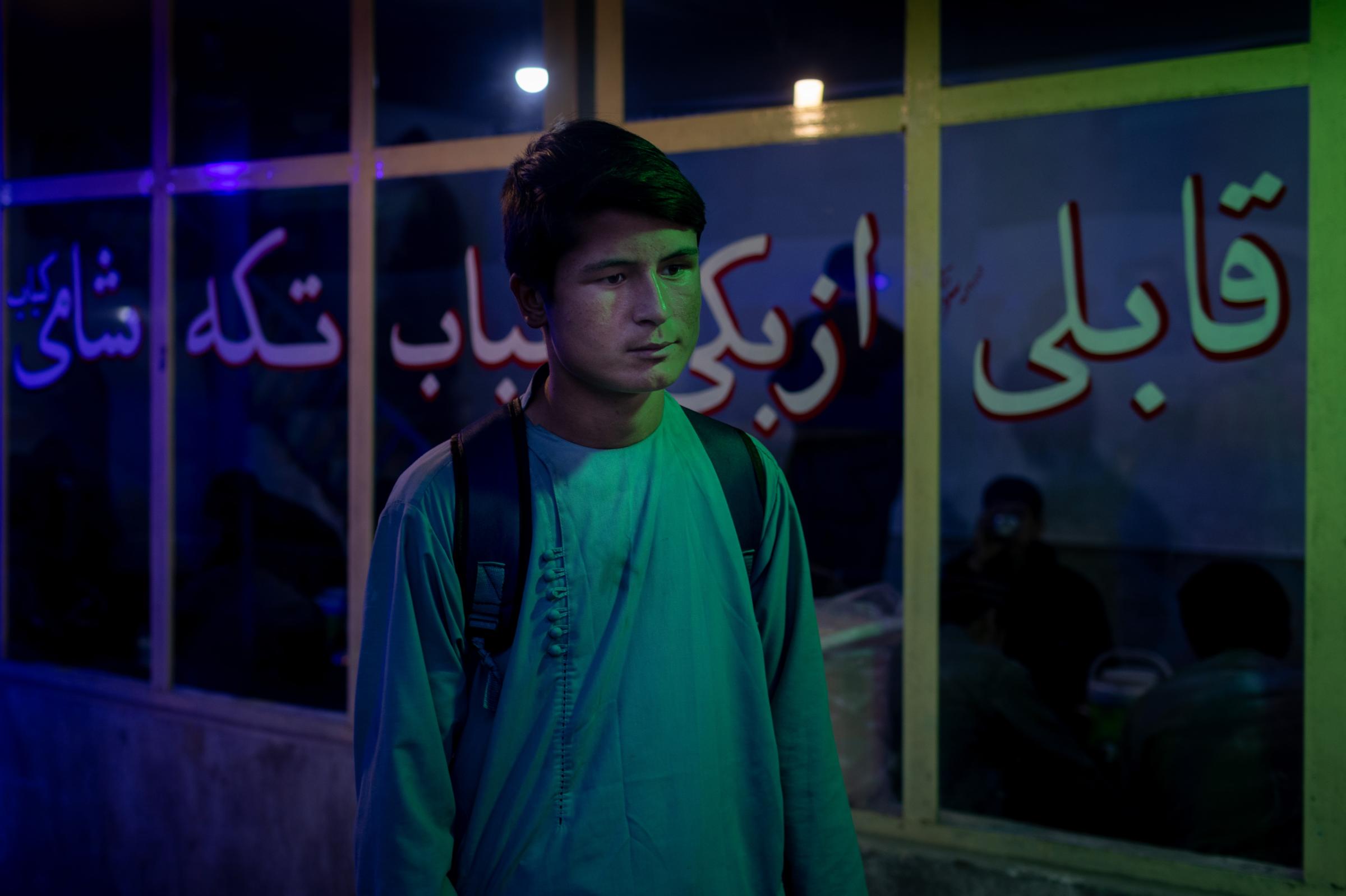 Shahabeddin, 17, from Kunduz stands at the bus station of the company area in Kabul. After trying...