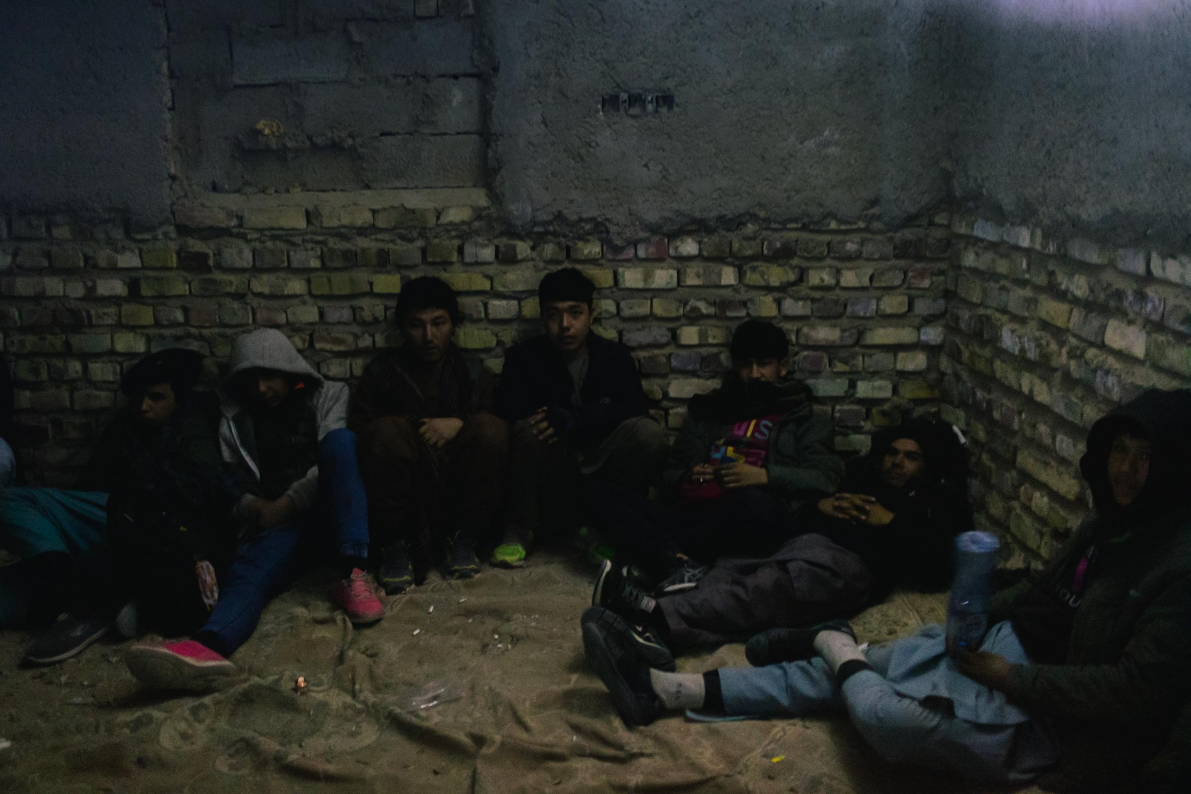 A few hundred yards from the Iranian border away, a group of young Afghans wait in a safe house...