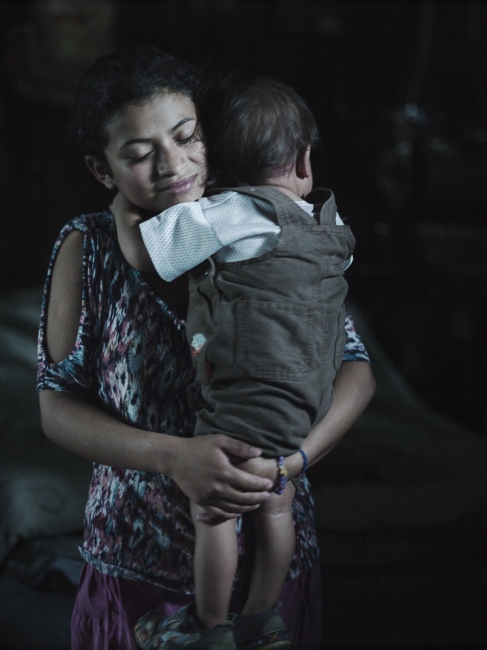 Children having Children -  Heidy holds Marcos David. She has found refuge in church...