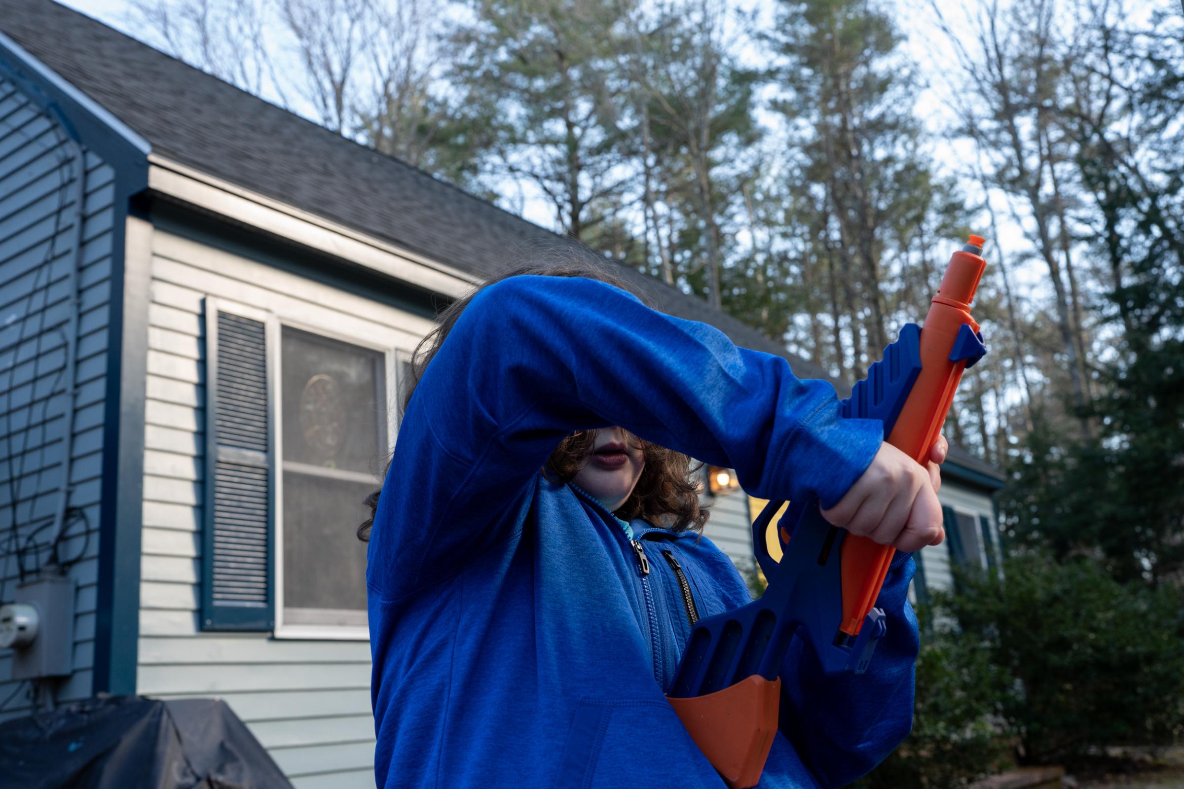 Science Magazine - Long Covid - Jaxson (9) plays with a toy gun in the yard, South...