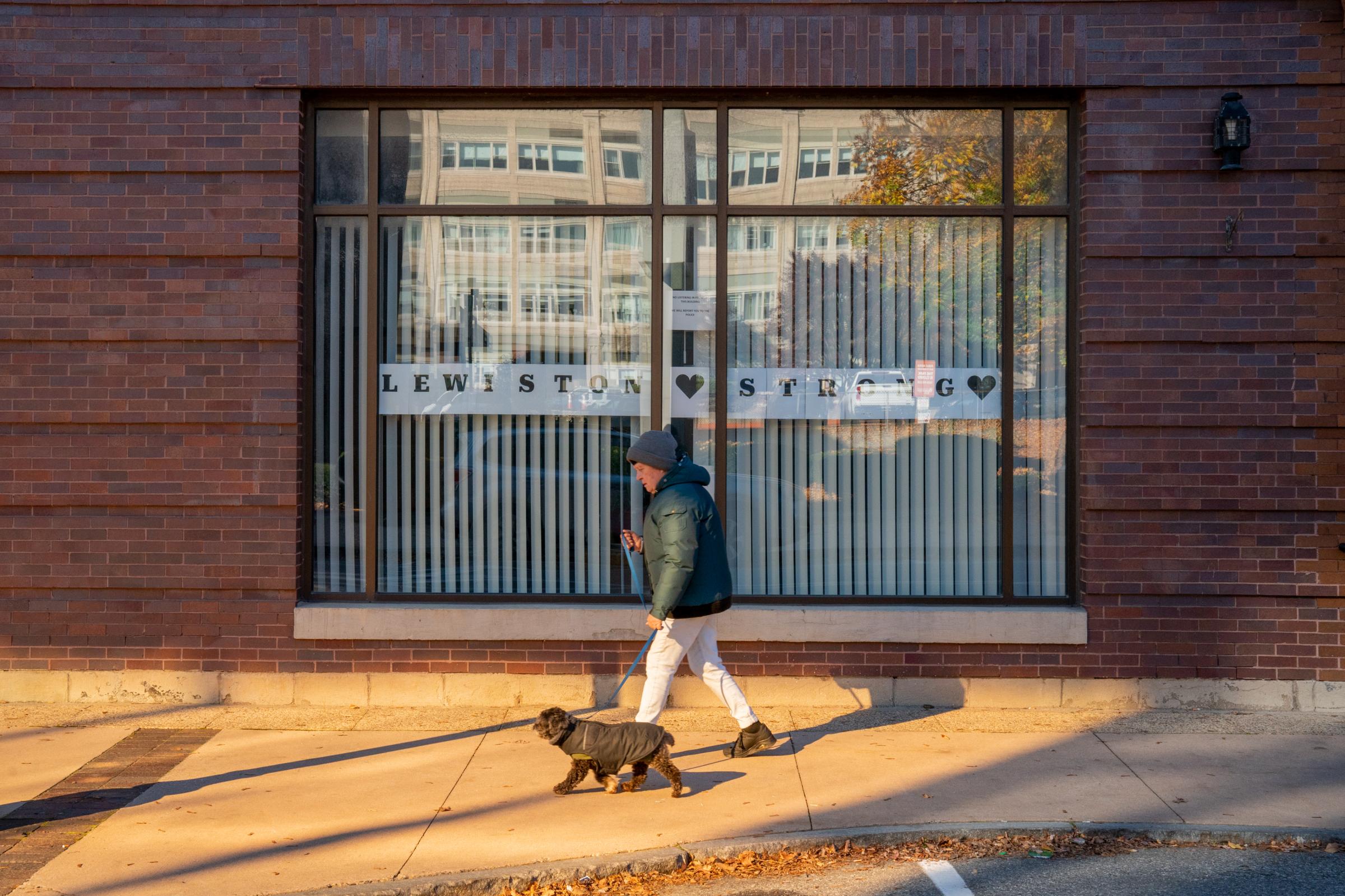 Wash Post - Aftermath of Lewiston Shooting  - Nancy Pettegrow walks her dog in downtown Lewiston on...