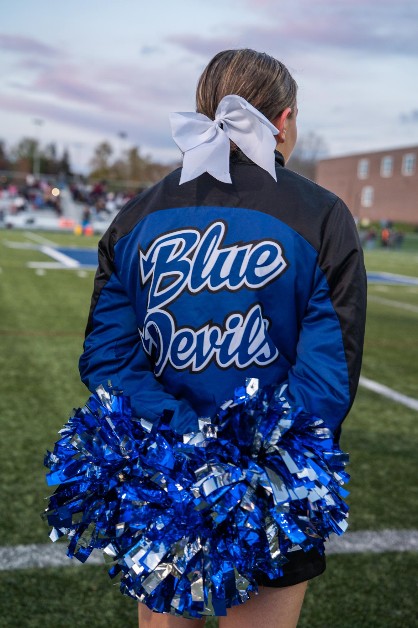 Wash Post - Aftermath of Lewiston Shooting  - A Cheerleader watches the Blue Devils from the sidelines...
