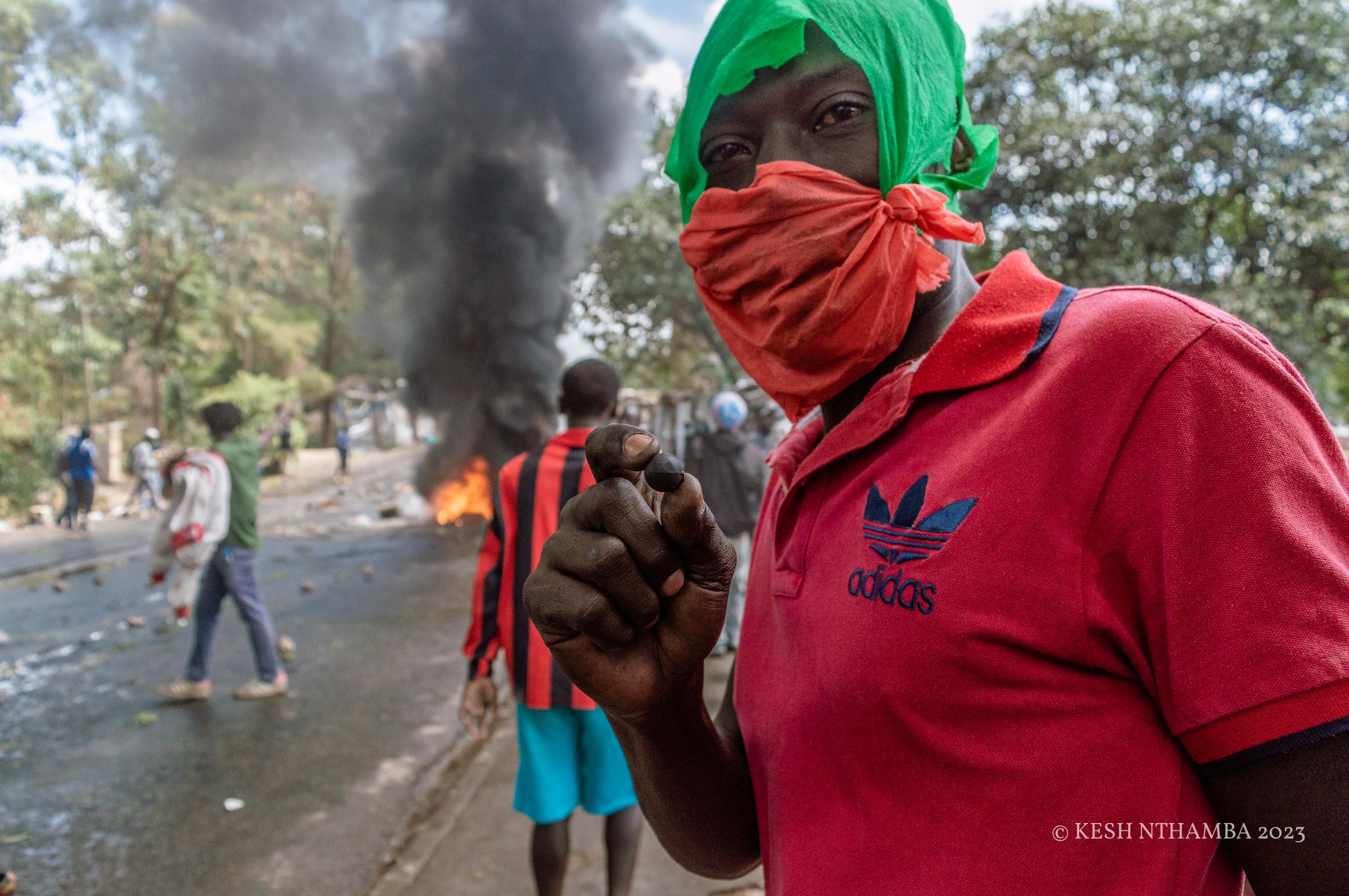 Anti-government Kibera Protests - A protestor shows a rubber bullet during the...