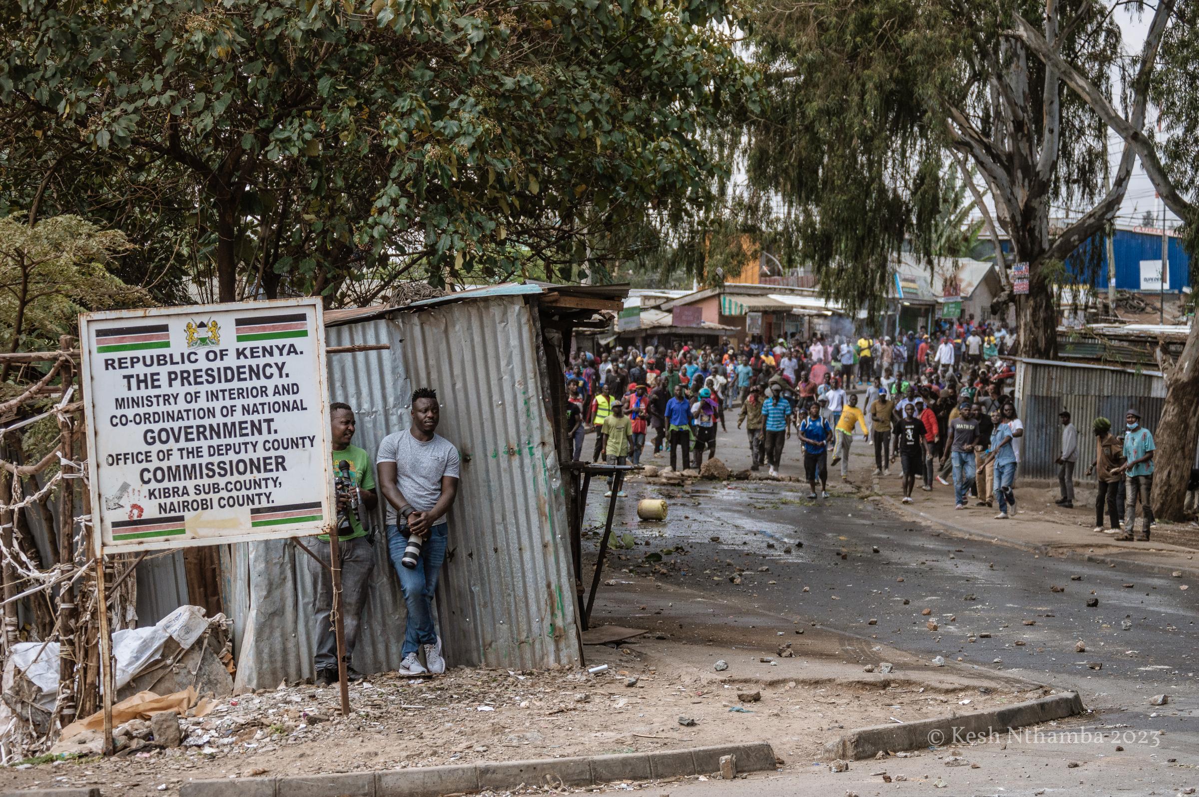 Anti-government Kibera Protests - Journalists take cover from rock-throwing protestors...