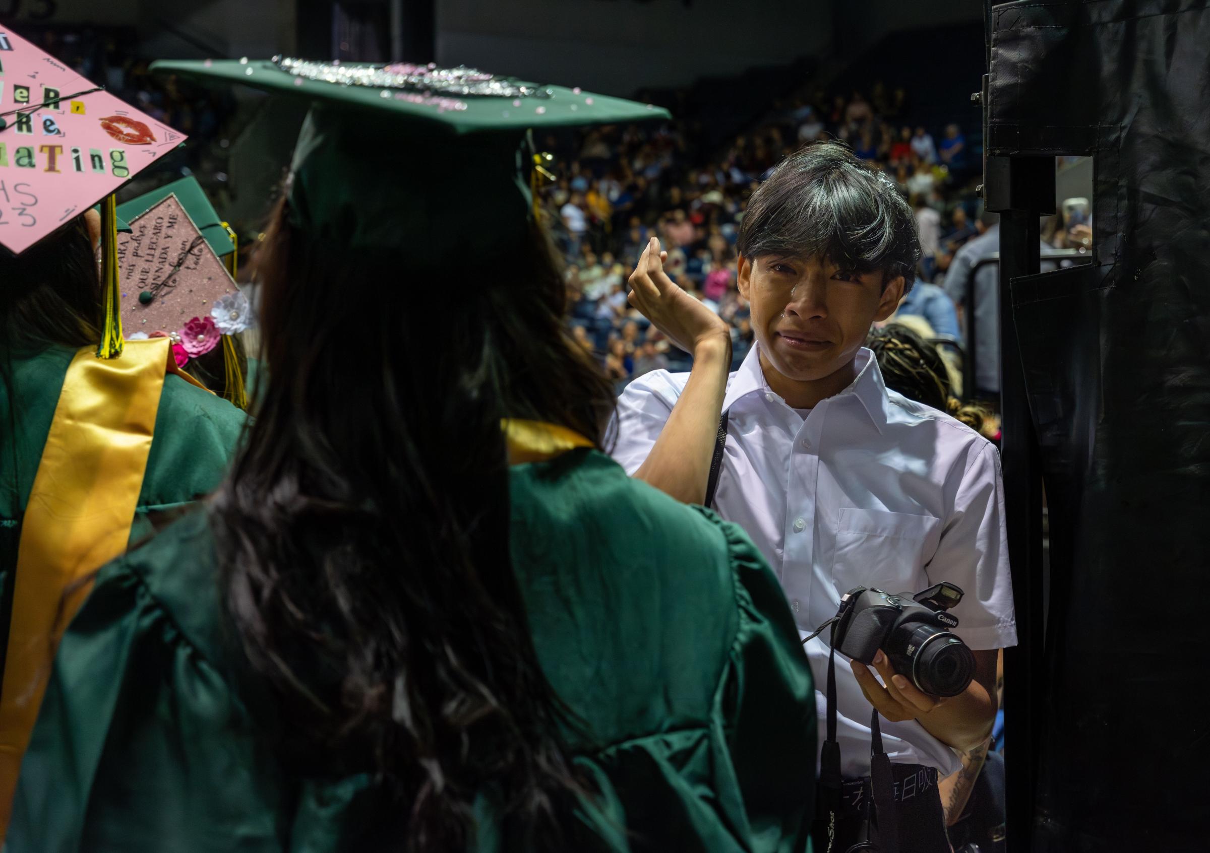 Graduation, at last (Photos for CalMatters) - Nathan Vonghom, a junior at Franklin High School tears up as he watches his senior year friends...
