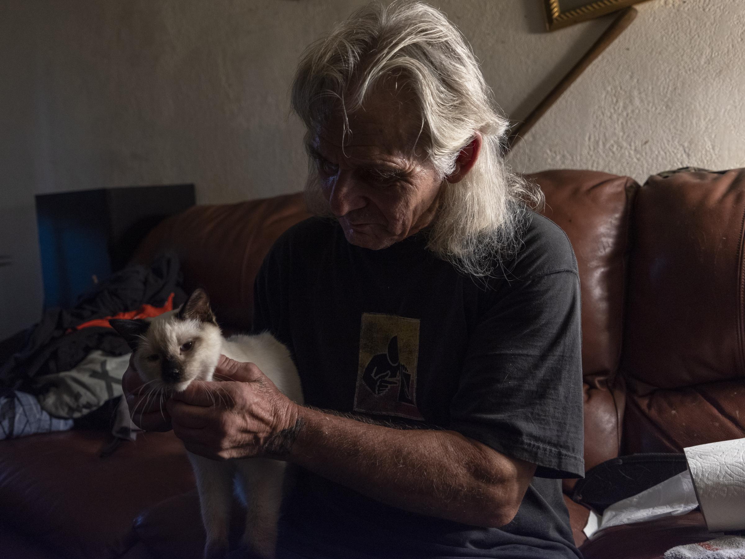 Heat Wave in Antioch - Earnest Hawkins pets his cat Simon at his apartment at...