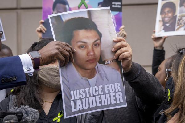 Image from Bay Area Work - Attorney John Burris passes around the photo of Laudemer...