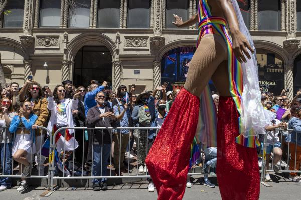 Image from Bay Area Work - Spectators cheer as a participant in costume waves at...