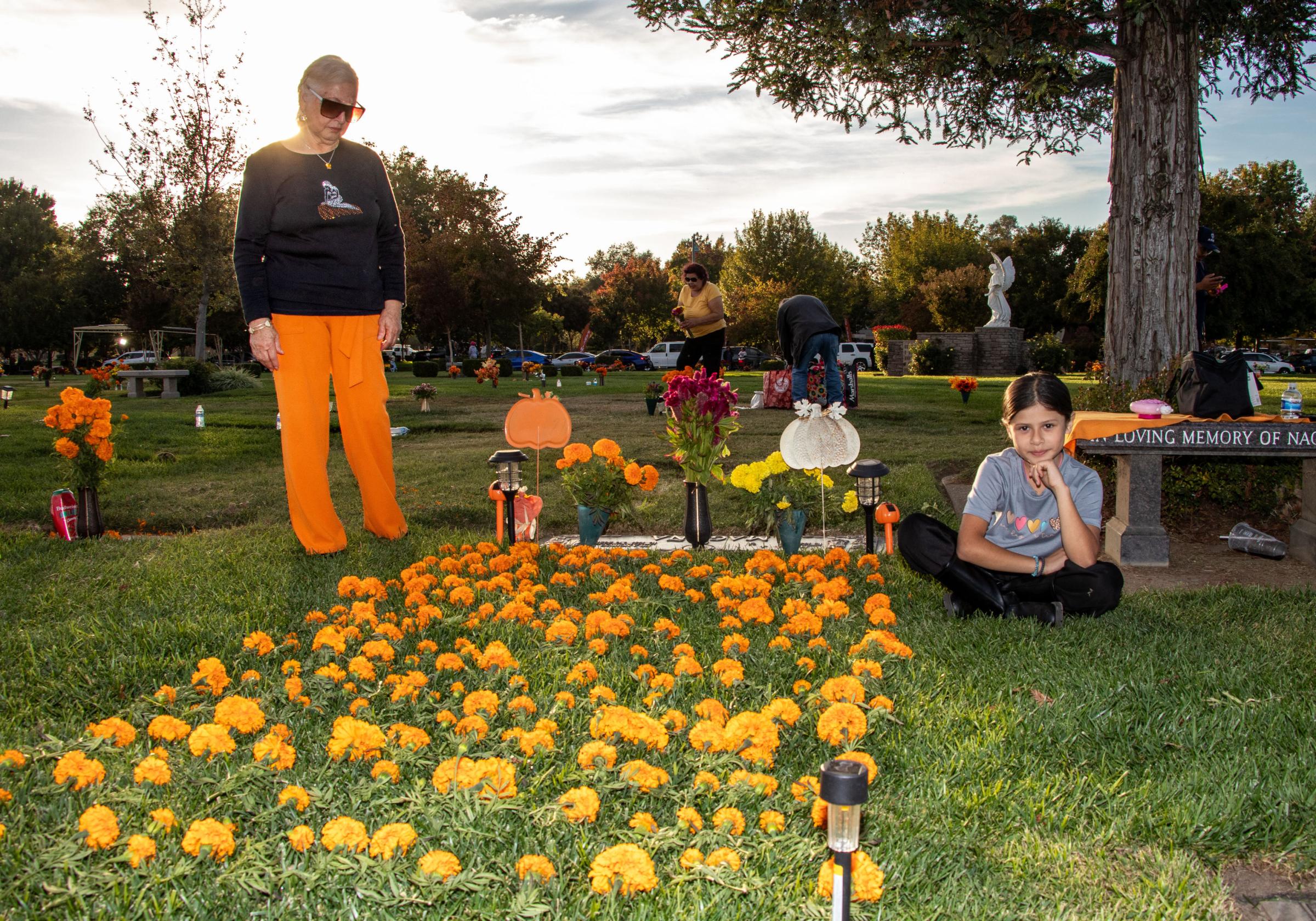 Dia de los Muertos - Maria Magana (left) and Aaliyah Chavez, 9, pose for a...