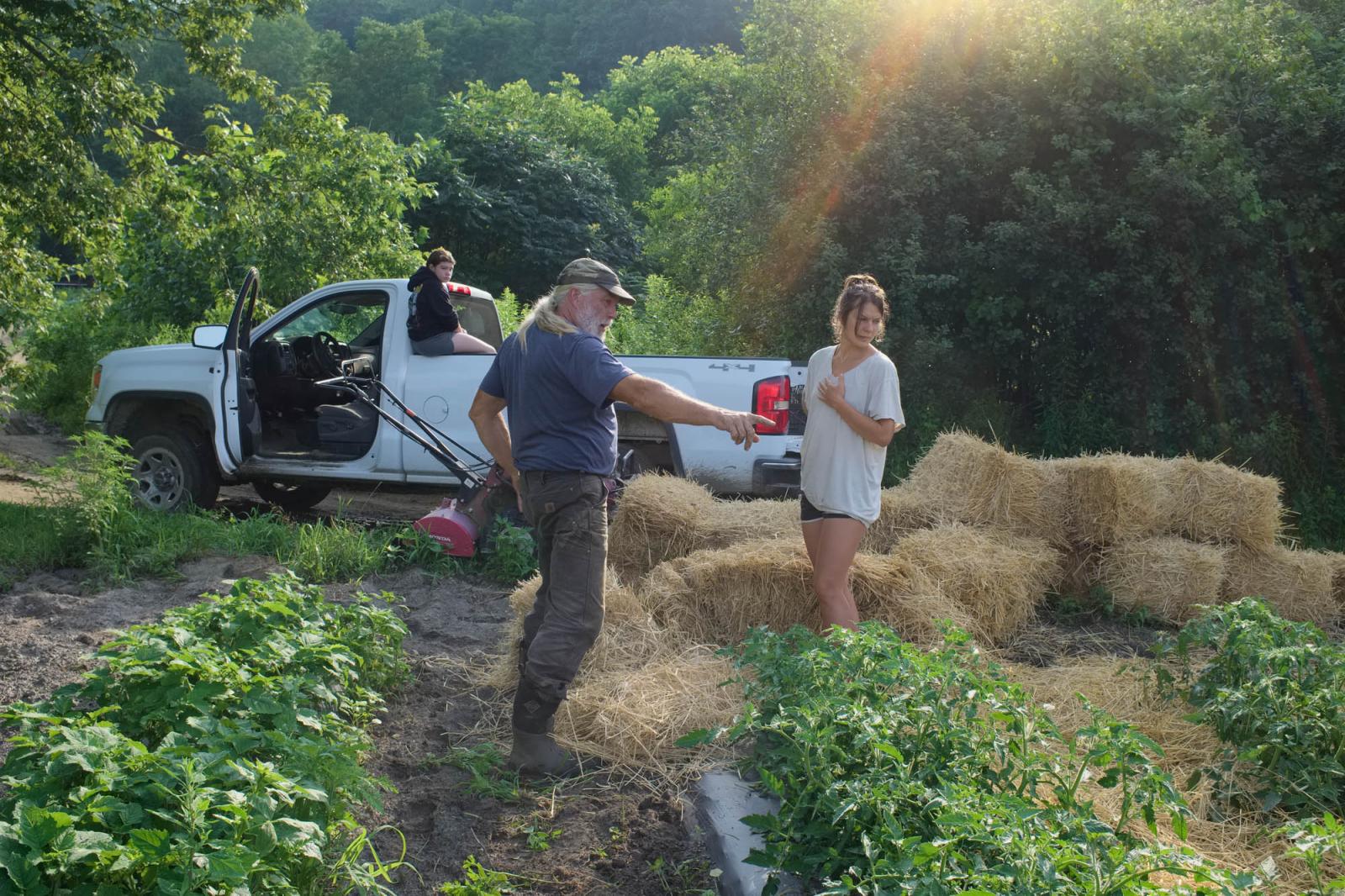 Farming for the Neighbors - Early morning at sunrise. Farmer Bruce Bickford explains to farmworker Robin Bigaj where to weed...