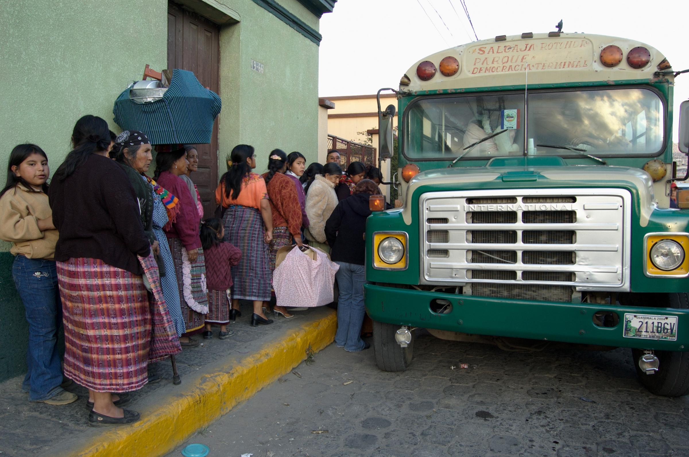 With God and Ayudante Across Guatemala - Guatemalan Maya women board a bus after shopping in the...