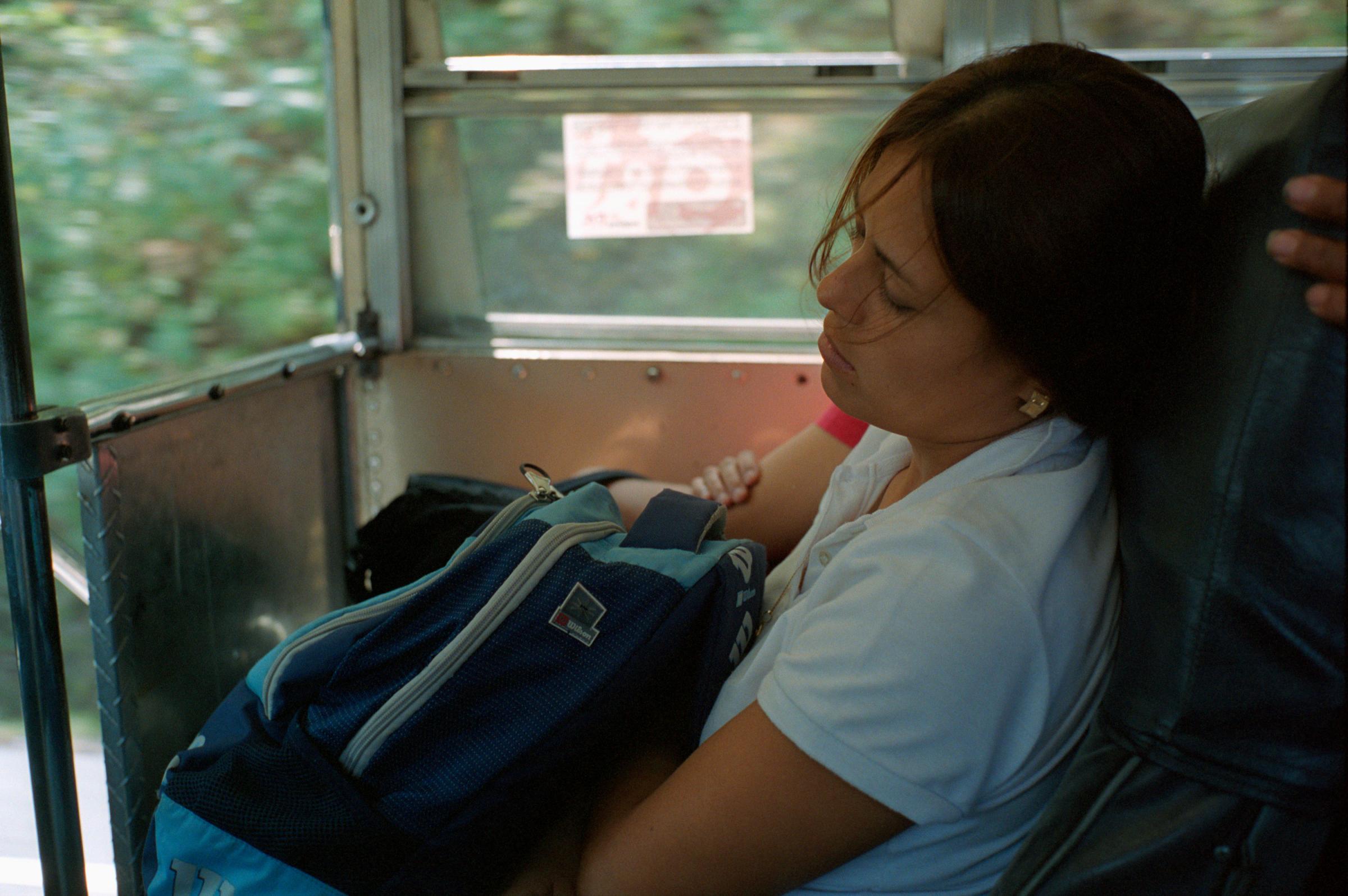 With God and Ayudante Across Guatemala - A Guatemalan woman sleeps during her bus trip from the...