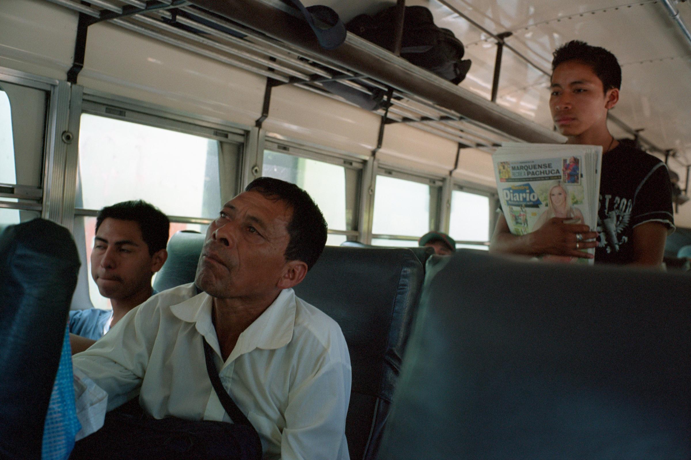 With God and Ayudante Across Guatemala - A man sells Nuestro Diario, “Our Newspaper”,...