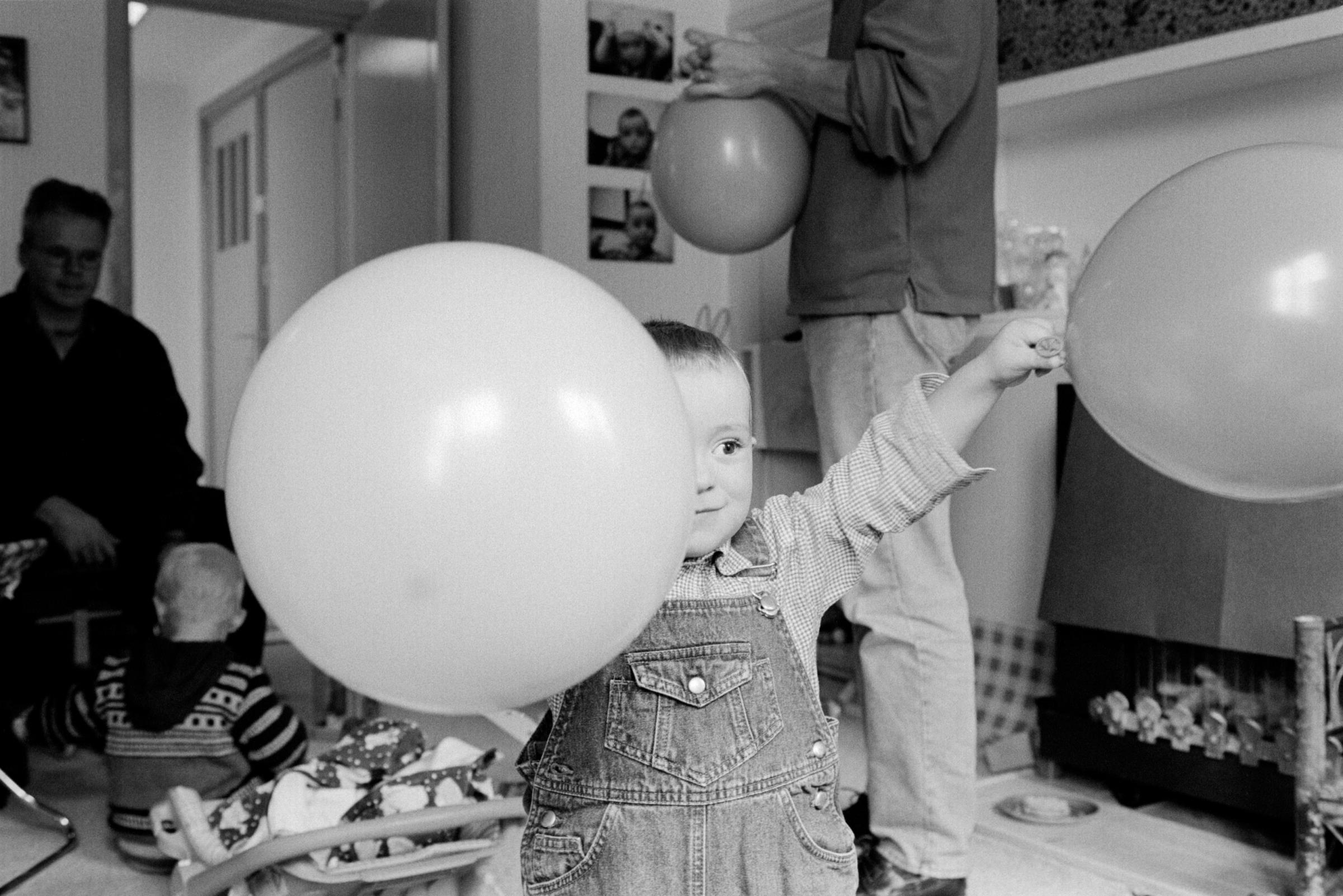 Happy Birthday! Dutch Children’s Parties - A boy waves balloons at this second birthday party. In...