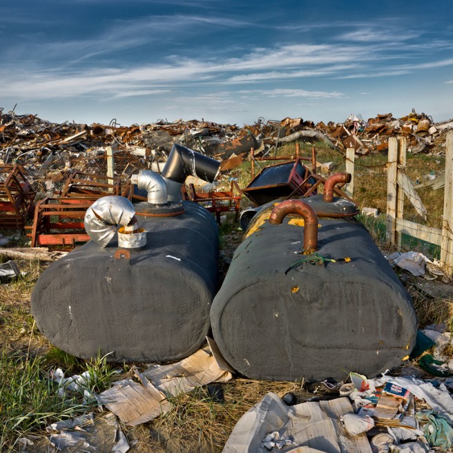 Piles of scrap metal and industrial appliances.