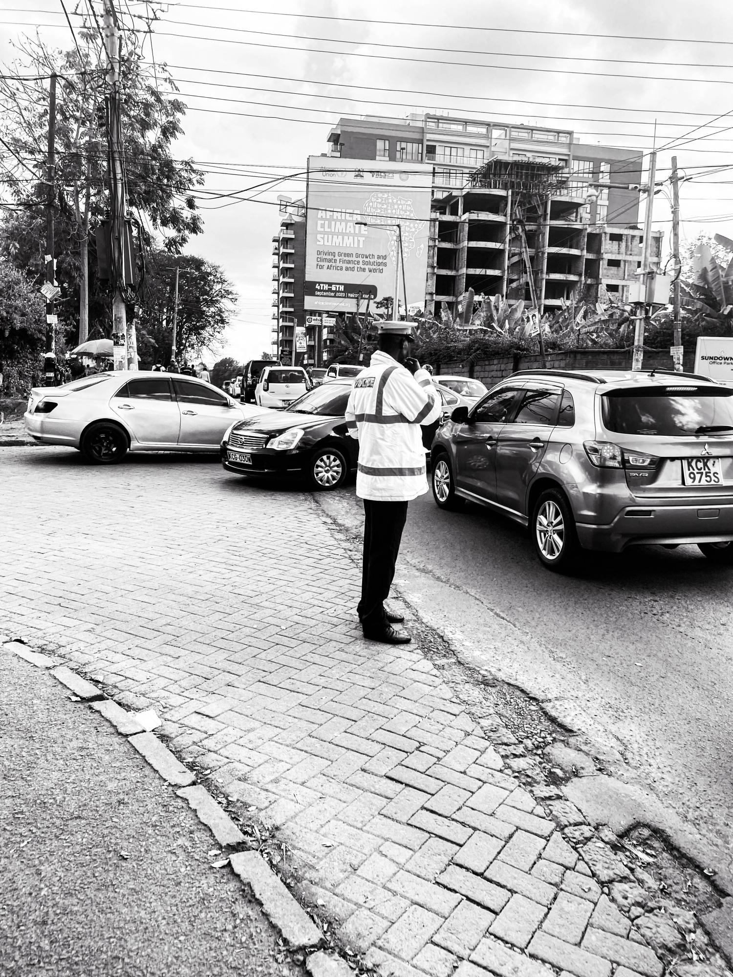 Nairobi  - the officer stands as a guardian, directing traffic with...