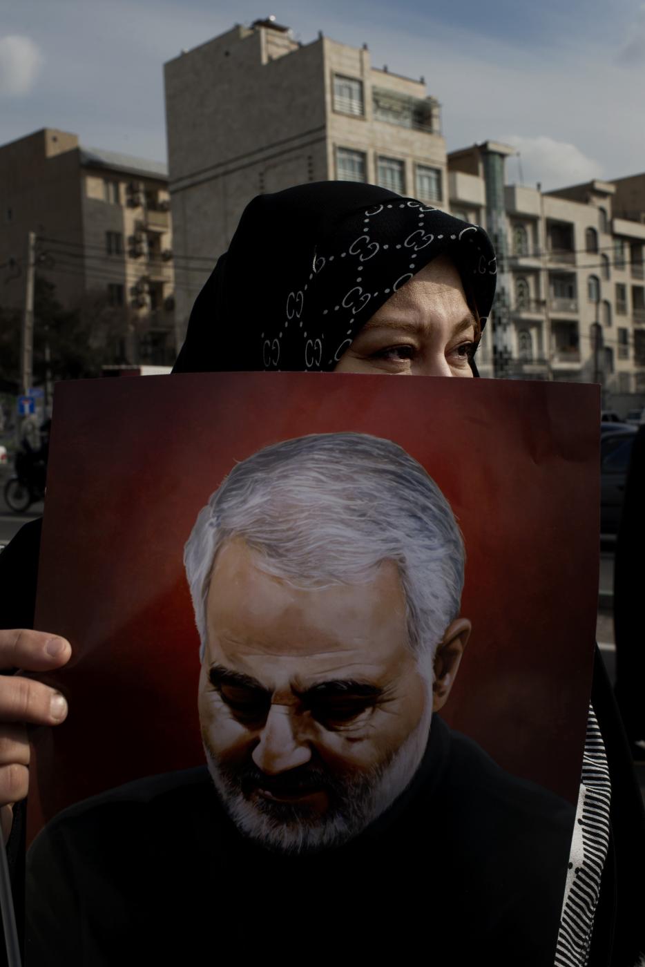 A woman holding a photo of Sole...ion, February 11, Tehran, Iran 
