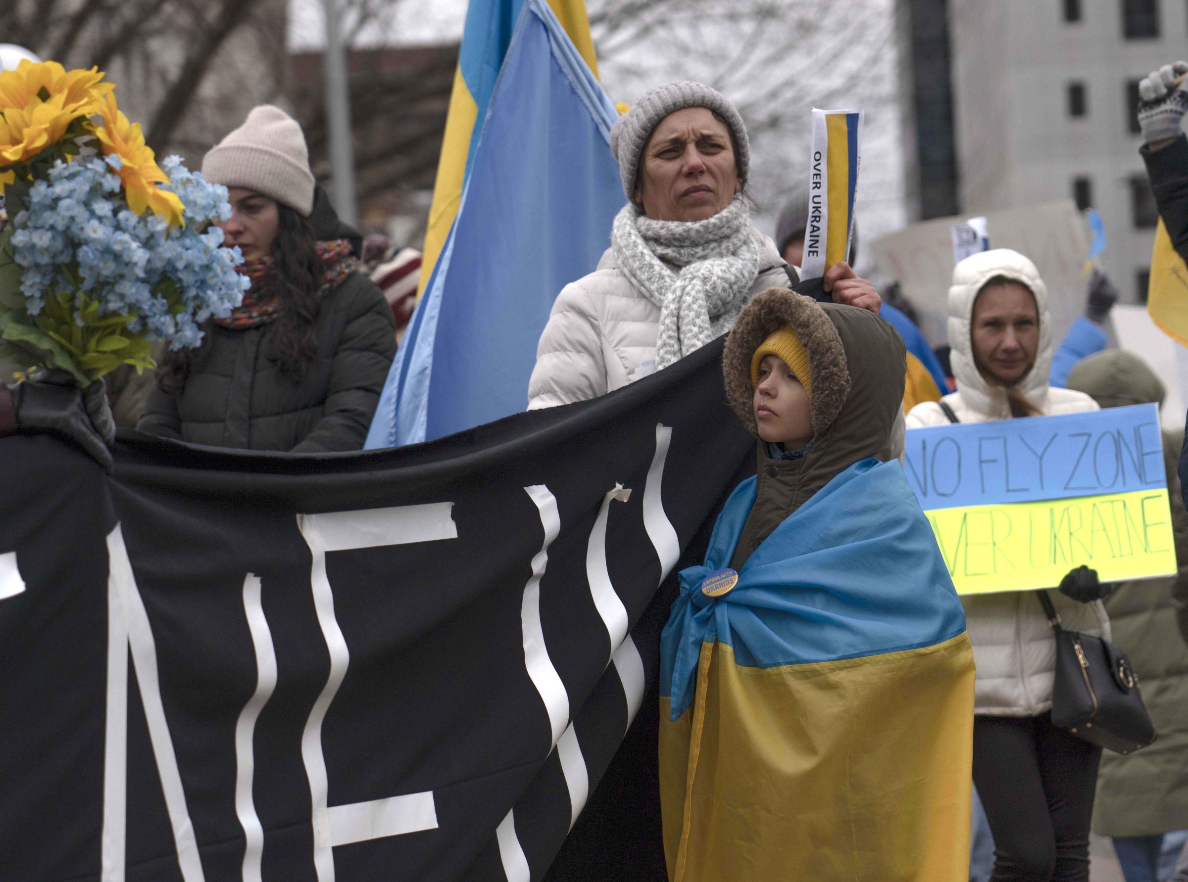 Slava Ukraini - Ukrainian-American protesters listen to a speech during a...