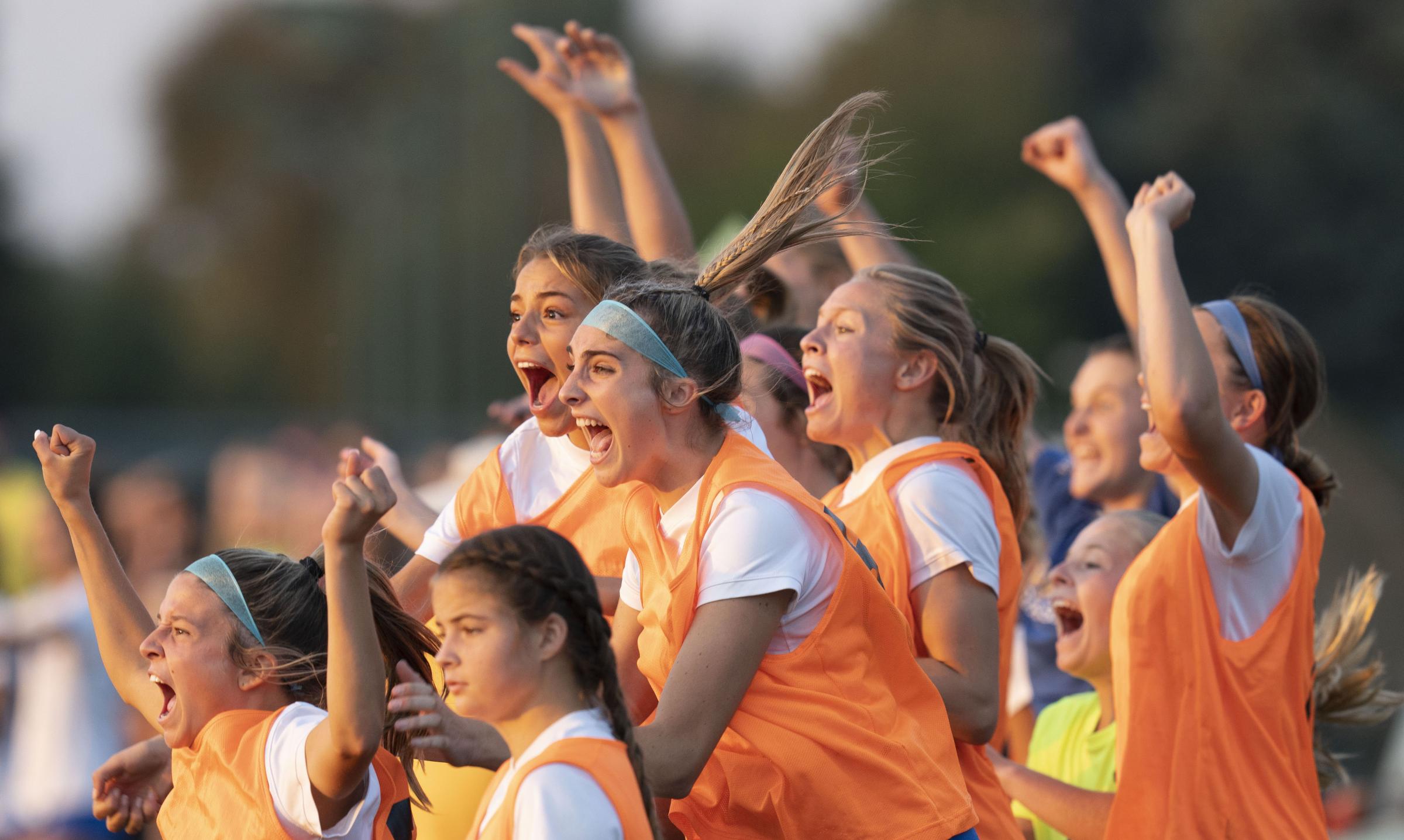 Sports - The Carmel sideline erupts after a goal Thursday, Oct. 6,...