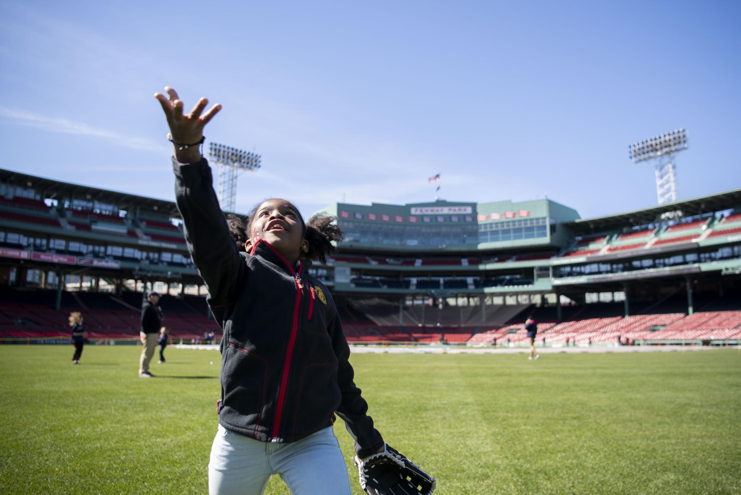 The 2023 Boston Red Sox  - April 8, 2023, Boston, MA: A kid plays in the outfield...